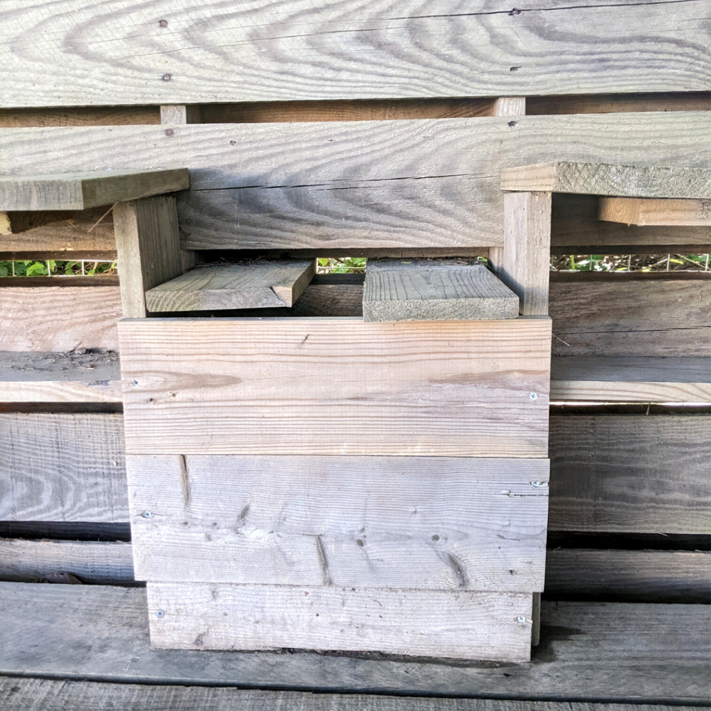 pallet wood shelves created to be a mud kitchen outside