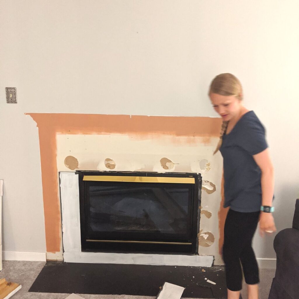 deconstructed fireplace mantle in the process of a fireplace makeover