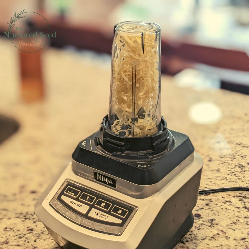 dehydrated onion flakes in a ninja blender on a granite counter top