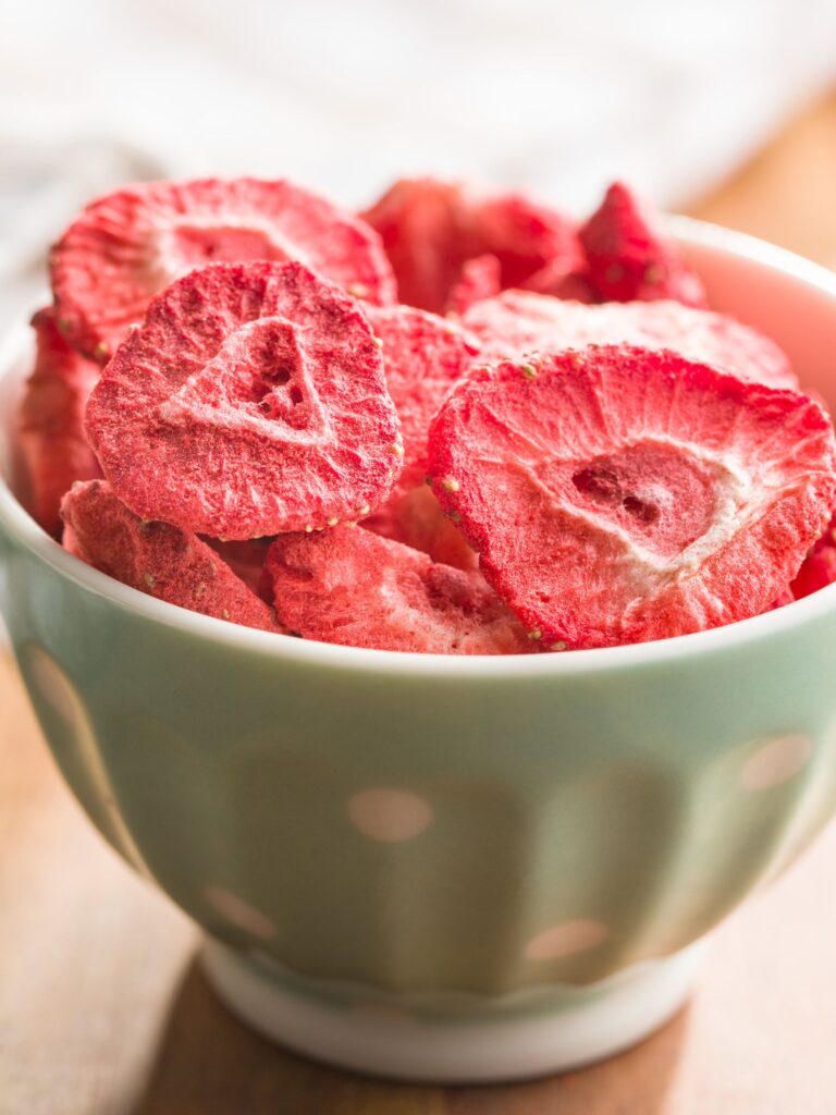 sliced freeze dried strawberries in a bowl as a snack